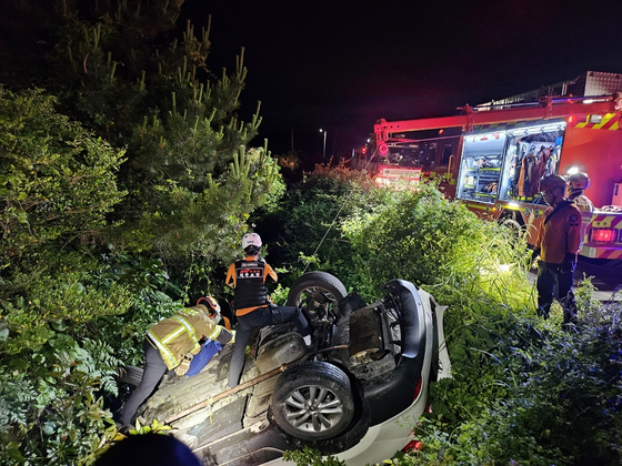 A car overturned in Seongsan-eup, Seogwipo on Jeju Island on Tuesday. [JEJU FIRE SAFETY HEADQUATERS]