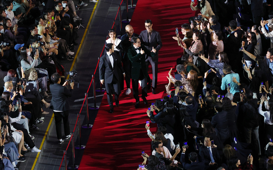 The cast of film “Believer 2” walks down the red carpet for the Busan International Film Festival’s opening ceremony held at the Busan Cinema Center in Haeundae District on Oct. 4, 2023. [YONHAP]