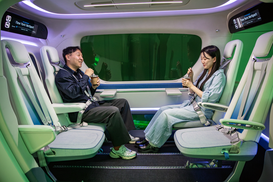 A mockup of a flying car that has seats that people can face each other. [HYUNDAI TRANSYS]