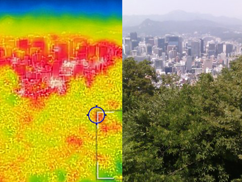 A thermal image of Seoul, captured from Namsan Mountain in the Jung District, Seoul. on Wednesday, highlights a significant temperature difference between the city's center and its forested areas. With temperatures in Seoul expected to soar to 35 degrees Celsius (95 degrees Fahrenheit) and a heat wave advisory issued at 10 a.m., the city center, crowded with buildings and people, appears red in the thermal image, indicating high temperatures, while the forested areas are shown in blue, representing cooler temperatures. [NEWS1]
