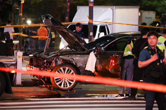 Police control the site where a Genesis G80 hit people and crashed into a guardrail near Seoul City Hall in central Seoul on July 1. [YONHAP]