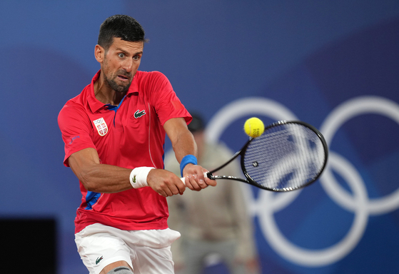 Novak Djokovic of Serbia returns the ball during a men's singles first round tennis match against Matthew Ebden of Australia at the 2024 Paris Olympics in Paris on September.  [XINHUA/YONHAP]