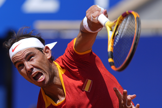 Spain's Rafael Nadal serves the ball to Serbia's Novak Djokovic during their men's singles second round match at the Paris Olympics on Monday at the Roland Garros stadium in Paris. [AP/YONHAP]