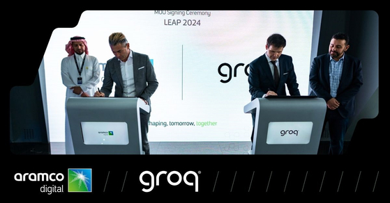 Executives from Aramco and Groq sign a memorandum of understanding for AI infrastructure development in March. [ARAMCO]