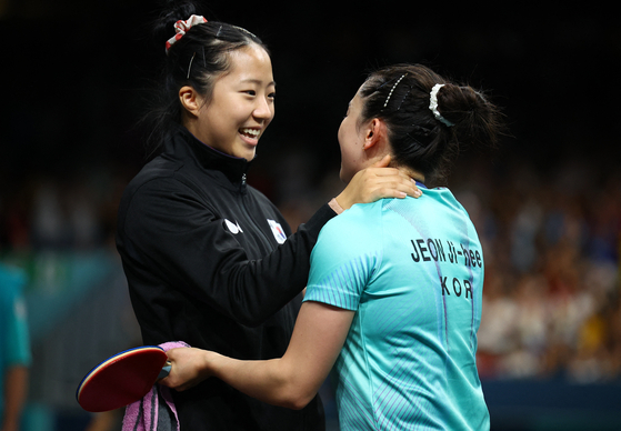 Korea's Shin Yu-bin celebrates with her teammate, Jeon Ji-hee, after Jeon won her singles match 3-0 against Germany for the women's team table tennis bronze medal ? Jeon's first medal, which came at her third straight Games. [REUTERS/YONHAP]