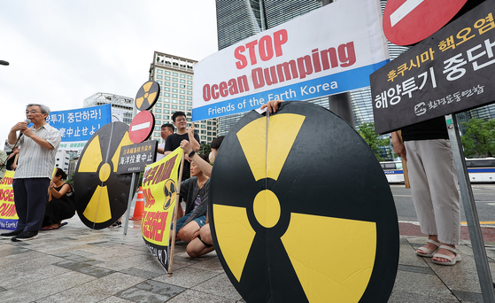 Members of civic environmental groups hold a press conference in front of the Japanese Embassy in central Seoul to protest Japan's discharge of the treated radioactive water from the ruined Fukushima Daiichi nuclear power plant. [NEWS1]