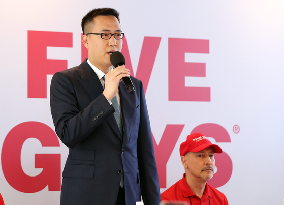 Hanwha Galleria Vice President Kim Dong-seon speaks at a brand conference for U.S. burger chain Five Guys in Seocho District, southern Seoul in June 2023. [NEWS1] 
