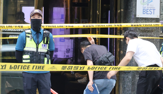 Officials from the Bucheon Hotel Fire Investigation Headquarters of the Gyeonggi Provincial Police Agency are seen at the scene of the fire on Monday. [YONHAP] 