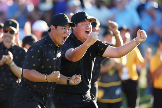 This file photo shows Tom Kim and Im Sung-jae react to a putt on the 18th green during day two of the 2022 Presidents Cup at Quail Hollow Country Club in Charlotte, North Carolina on Sept. 23, 2022.  [GETTY IMAGES]