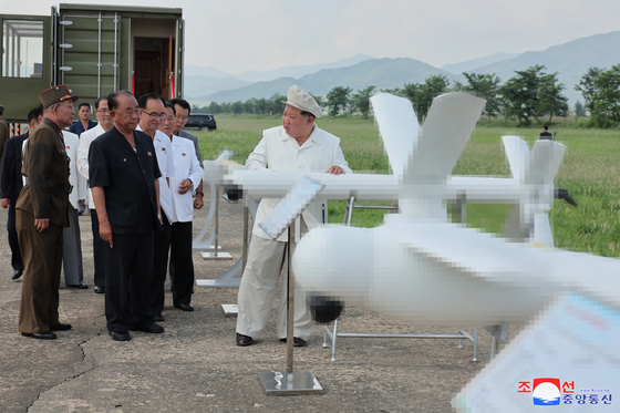 North Korean leader Kim Jong-un, right, is seen during an on-site overview of the Academy of National Defense Science on Aug. 26. [YONHAP] 