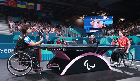 Moon Sung-hye, left, competes in the women's singles semifinals against Zhang Bian of China at the 2024 Paris Paralympic Games in Paris on Wednesday. [NEWS1] 