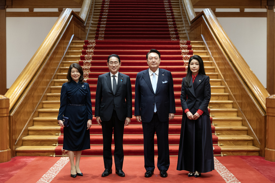 President Yoon Suk Yeol, center right, and first lady Kim Keon Hee, right, pose for a photo with Japanese Prime Minister Fumio Kishida, center left, and Japanese first lady Yuko Kishida ahead of their dinner banquet at the Blue House in central Seoul on Friday. [PRESIDENTIAL OFFICE] 