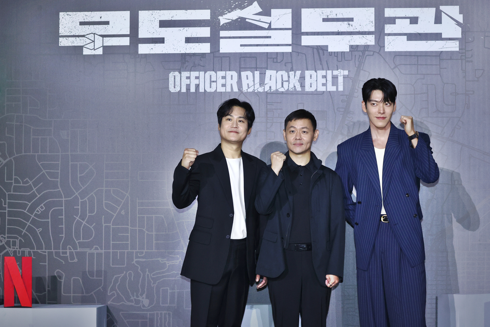From left, actor Kim Sung-kyun, director Kim Joo-hwan and actor Kim Woo-bin pose for a photo during a press conference for Netflix's action film ″Officer Black Belt″ held in Gwangjin District, eastern Seoul, on Tuesday. [YONHAP]
