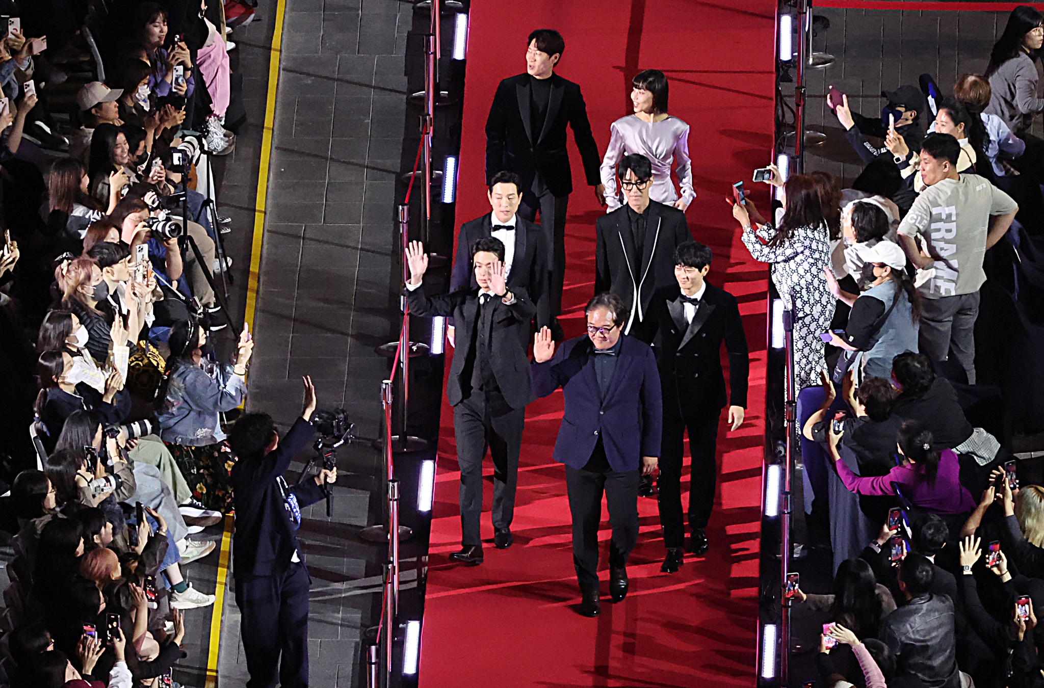 The cast and director of the 29th Busan International Film Festival's opening film ″Uprising″ walk down the red carpet ahead of the festival's opening ceremony held at the Busan Cinema Center in Haeundae District on Wednesday. [YONHAP]