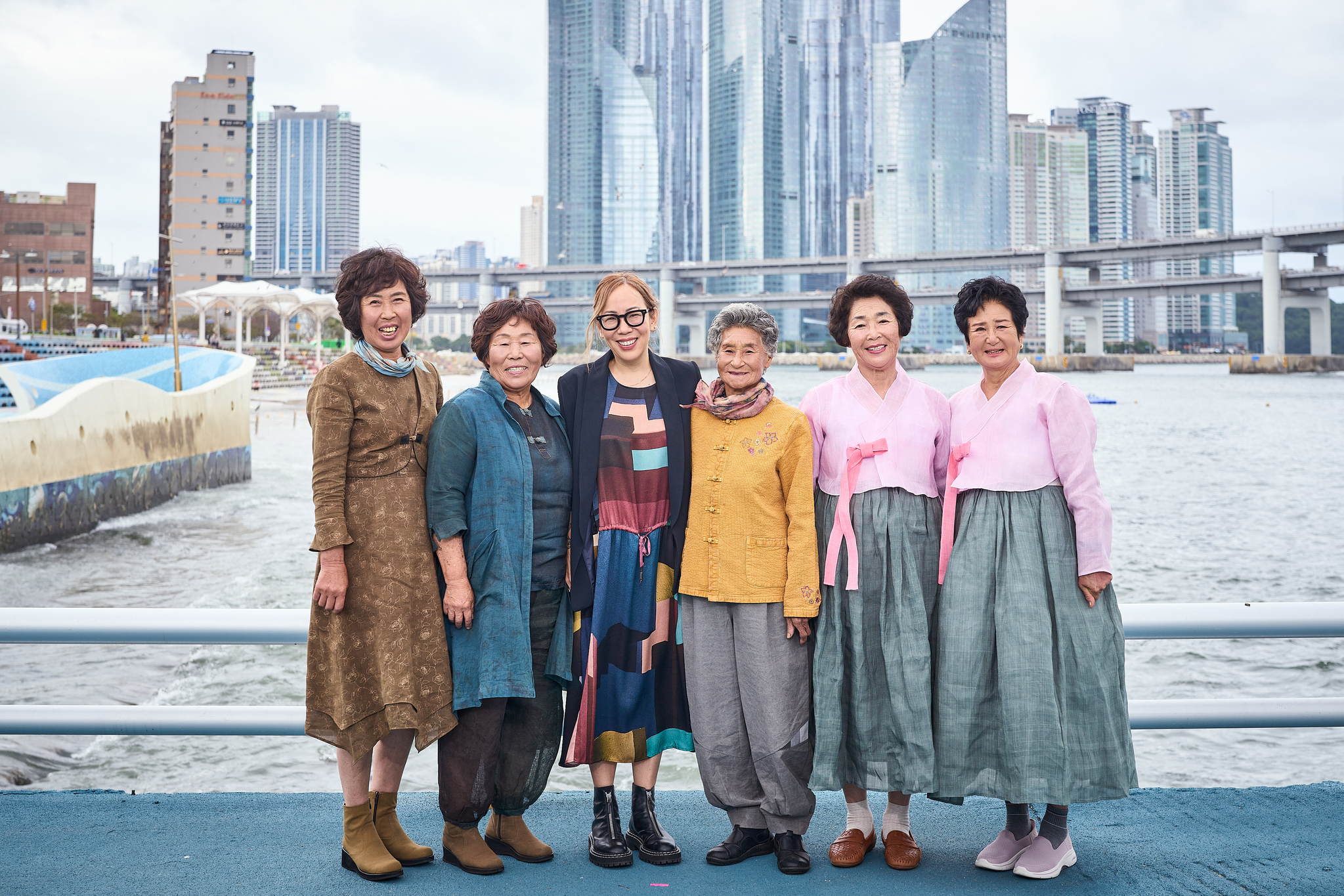 Director Sue Kim, third from left, and the haenyeo of documentary film "The Last of the Sea Women" pose for a photo. From left, haenyeo Kang Joo-hwa, Jeong Young-ae, director Kim, haenyeo Lee Geum-ok, Hyun In-hong and Park In-sook [APPLE TV+]