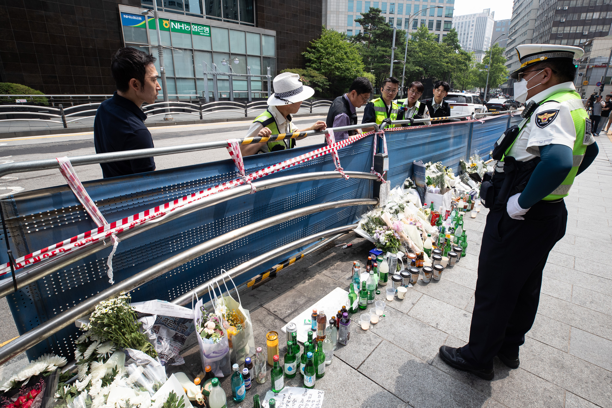 Police officers inspect the site of a car crash that killed nine people near Seoul City Hall in central Seoul on July 4, three days after the accident. [NEWS1] 