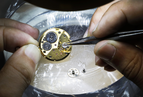 Hyun works on a watch [PARK SANG-MOON] 