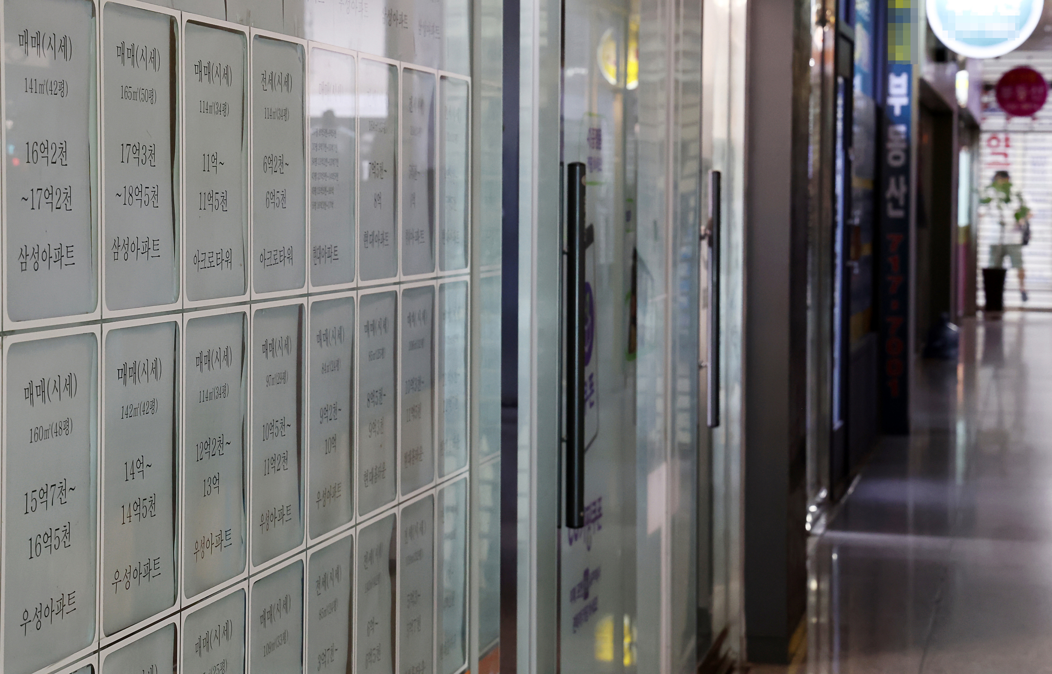 An advertisement at a real estate agency in Seoul on Sunday shows rental and sale prices for apartments.