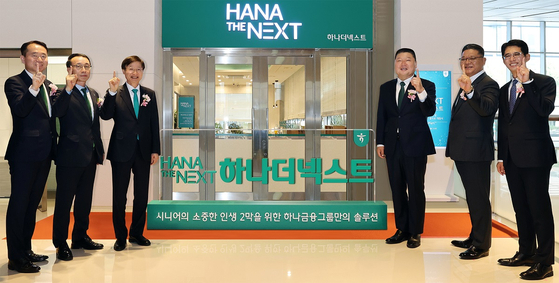 Hana Bank CEO Lee Seung-yeol, third from left, and television personality Kang Ho-dong, fourth from left, pose for the camera during Monday's opening ceremony for Hana The Next in Jongno District, central Seoul. [HANA FINANCIAL GROUP]