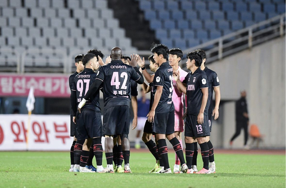 Bucheon FC 1995 players high-five each other during a game against Chungbuk Cheongju FC at Bucheon Stadium in Bucheon, Gyeonggi on Oct. 5 in an picture posted to the club's official Instagram account. The game was the 300th home fixture in the club's history.  [SCREEN CAPTURE]
