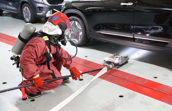 Hyundai Glovis' EV-Drill Lance fire-extinguishing tools are demonstrated on a car carrying ship. [HYUNDAI GLOVIS]