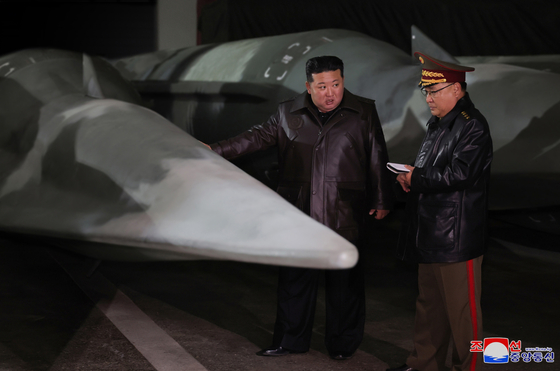North Korean leader Kim Jong-un, left, inspects what is believed to be a Hwasong-12Na intermediate-range hypersonic missile at an undisclosed strategic missile base, as shown in this photo released by the North's Korean Central News Agency on Wednesday. [YONHAP]