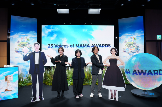 Producers of the 2024 MAMA Awards pose for photos alongside pictures of hosts Park Bo-gum and Kim Tae-ri prior to a press briefing held on Oct. 29 at the CJ ENM headquarters building in western Seoul. [CJ ENM]