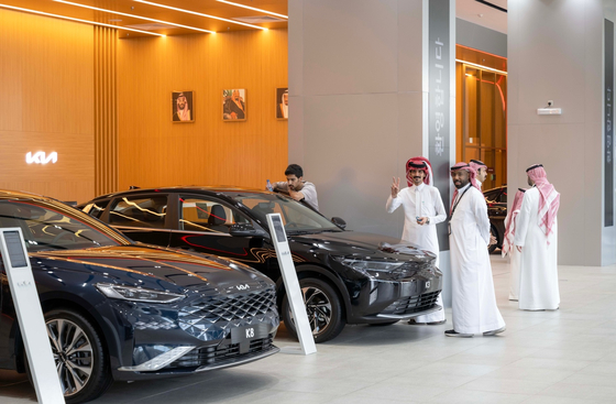 Customers check out Kia cars at a showroom in Jeddah, Saudi Arabia. [KIA]