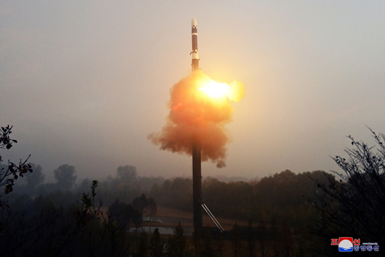 North Korea fires the new Hwasong-19 intercontinental ballistic missile, guided by its leader, Kim Jong-un, in this photo released by North Korea's state-run Korean Central News Agency on Friday. [YONHAP]