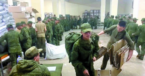 A screengrab shows soldiers, believed to be North Koreans, receiving basic supplies at a Russian training base in a video provided by the Ukrainian Center for Strategic Communication and Information Security, also known as Spravdi. [SCREEN CAPTURE]