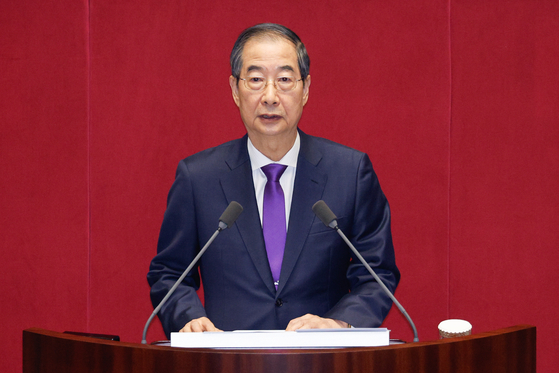 Prime Minister Han Duck-soo reads President Yoon Suk Yeol's budget speech during a plenary session at the National Assembly in Seoul on Monday. [NEWS1]