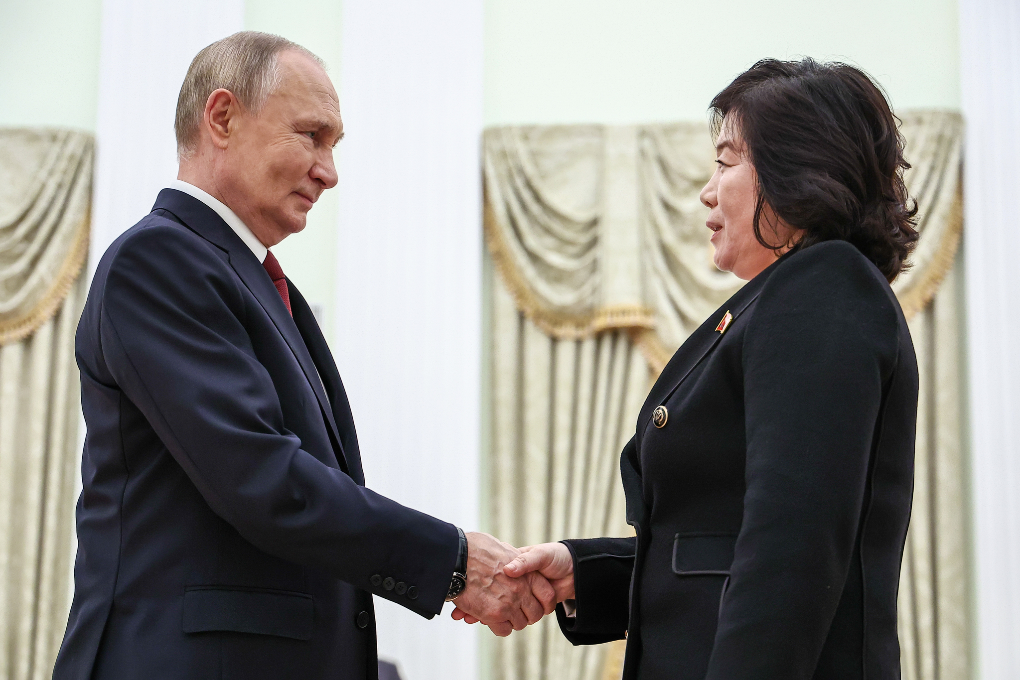 Russia's President Vladimir Putin, left, shakes hands with North Korean Foreign Minister Choe Son-hui during a meeting at the Kremlin in Moscow. [TASS] 