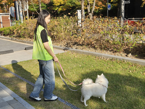 Koh Mi-hee, a 26-year-old volunteer, participates in a dog walking activity with a Pomeranian dog from the Seoul Animal Care Center in Mapo District, western Seoul. [LEE SU-MIN]