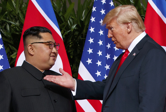 U.S. President-elect Donald Trump, right, meets with North Korean leader Kim Jong-un on Sentosa Island in Singapore on June 12, 2018, during Trump's first term. [AP/YONHAP]