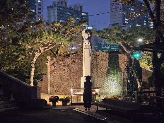 A person prays to the Virgin Mary statue at Yangcheon District, western Seoul, on Monday. [LEE SU-MIN]