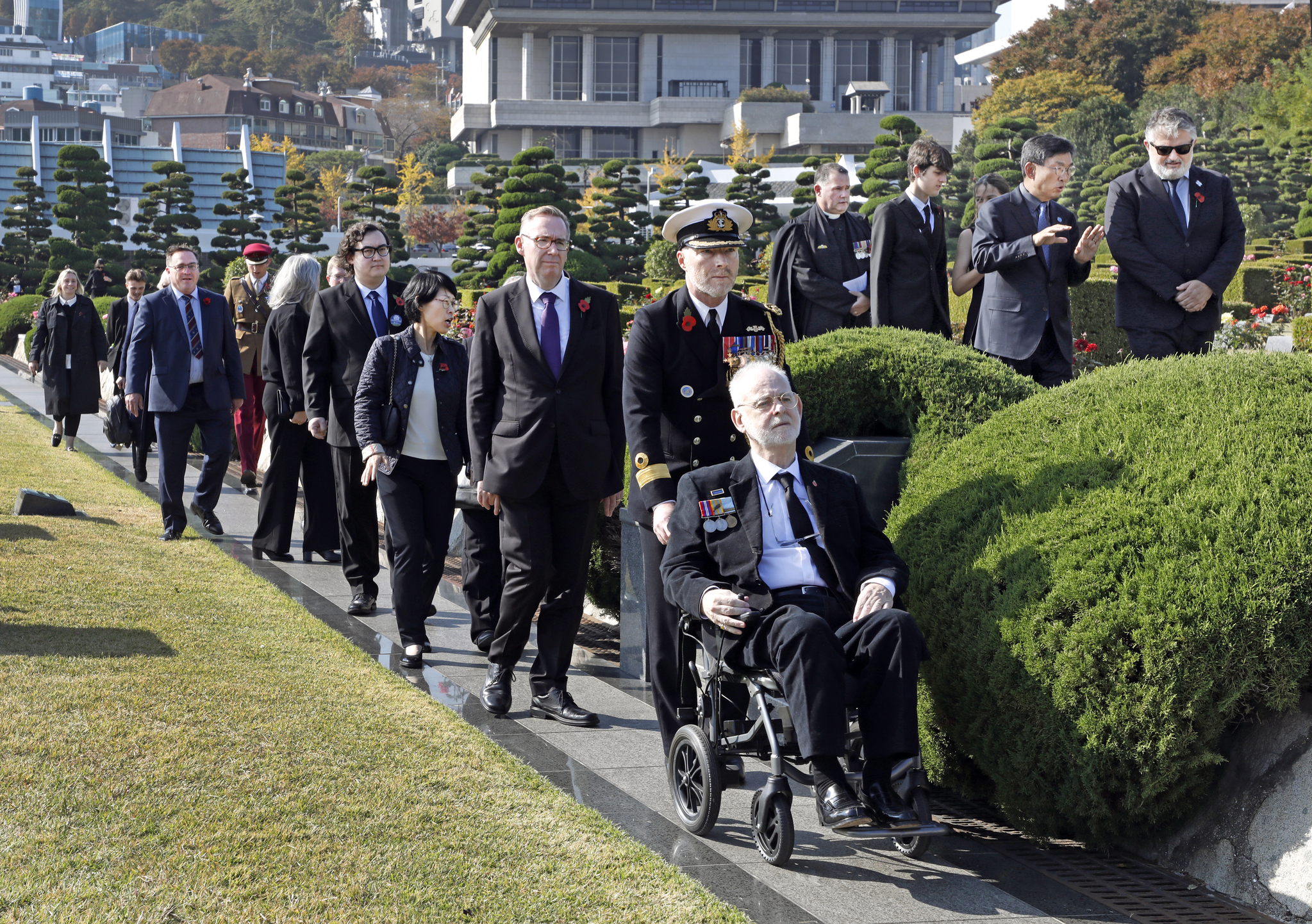 Sgt. Donald Northey's son Michael Northey, first from right, is accompanied out from Tuesday's rededication ceremony at the United Nations Memorial Cemetery in Busan by Brig. Gen. Andy Lamb, the British defense attache in Korea, and British Ambassador to Korea Colin Crooks, second and third from right. [PARK SANG-MOON]