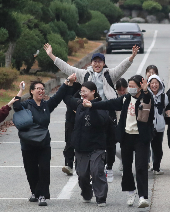 Test-takers cheer as they exit Yeongbok Girls' Middle School in Suwon, Gyeonggi, after completing the College Scholastic Ability Test (CSAT), the most important test for university hopefuls. [NEWS1]