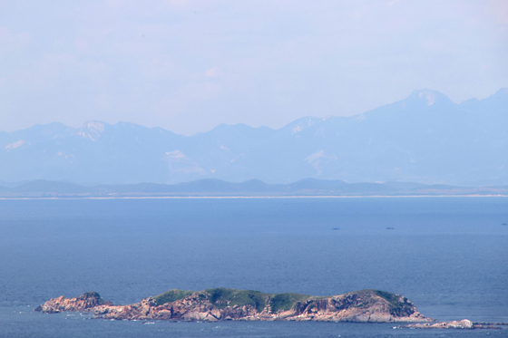 This photo, provided by South Korea's Ongjin county on June 1, 2024, captures a North Korean region near the western inter-Korean border. [YONHAP]