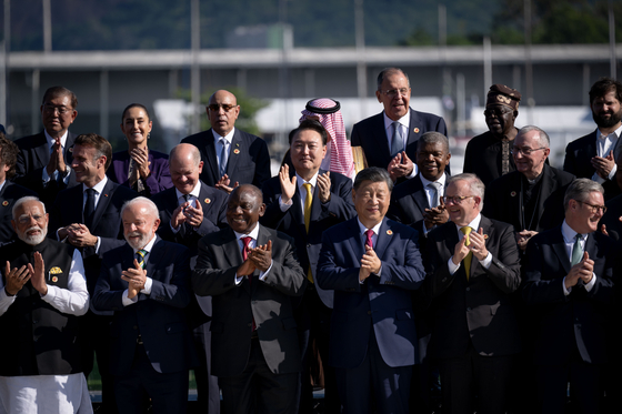South Korean President Yoon Suk Yeol, second row center, poses for photos with other G20 countries’ leaders during the launch ceremony of the Global Alliance Against Hunger and Poverty as part of the G20 summit at the Museum of Modern Art in Rio de Janeiro, Brazil, on Monday. [JOINT PRESS CORPS]