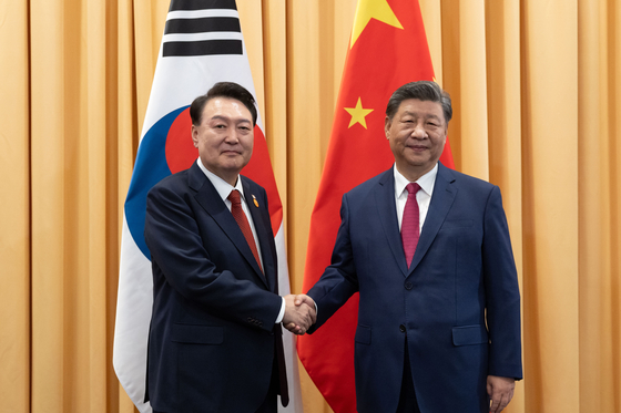 President Yoon Suk Yeol, left, shakes hands with Chinese President Xi Jinping during their meeting at a hotel in Lima, Peru, on Nov. 16, 2024, on the sidelines of the Asia-Pacific Economic Cooperation summit. [POOL/YONHAP]