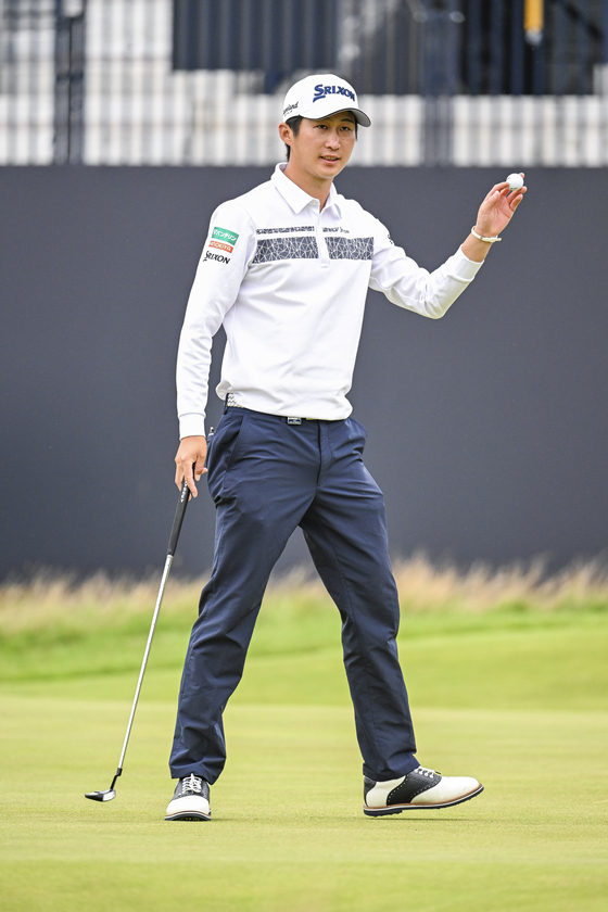 Rikuya Hoshino smiles and waves his ball to fans on the 18th hole during the third round of The 151st Open Championship at Royal Liverpool Golf Club in Hoylake, England on July 22, 2023.  [GETTY IMAGES]