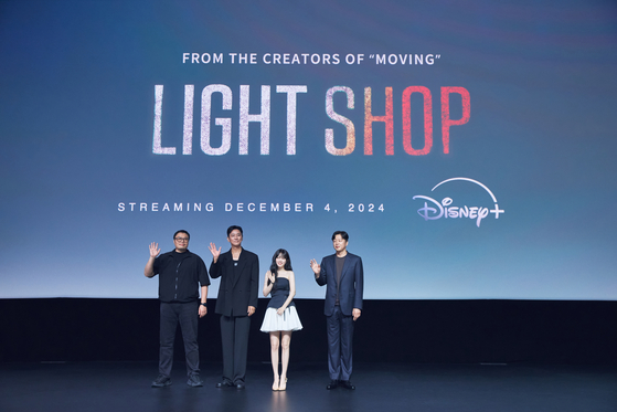 From left, screenwriter and webtoonist Kang Full, actors Ju Ji-hoon, Park Bo-young and director Kim Hee-won pose for a photo during a press conference for Disney+'s upcoming series ″Light Shop″ held at Marina Bay Sands in Singapore on Wednesday. [WALT DISNEY COMPANY KOREA]