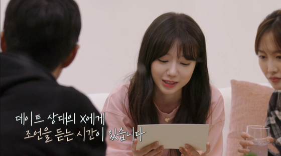 A scene from ″Transit Love″ shows a cast member reading advice from her love interest's ex. [SCREEN CAPTURE]