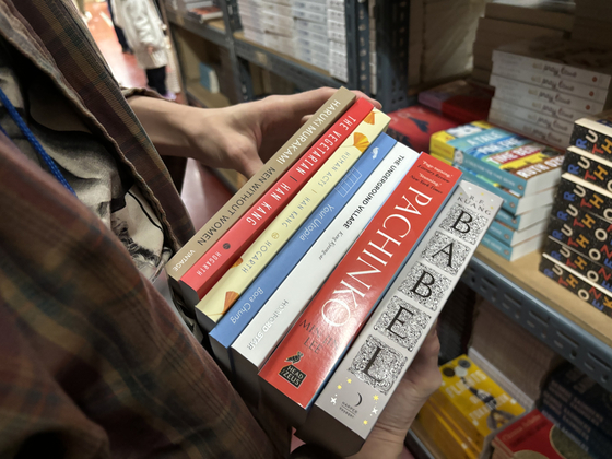 Books that Dahlia Davis, 24, picked out for herself at Tongbang Books' Open House book sale in Seongdong District, eastern Seoul, on Saturday [LEE JIAN]