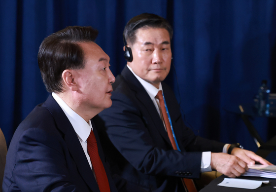 National Security Adviser Shin Won-sik, right watches Korean President Yoon Suk Yeol speak at a trilateral summit with the leaders of the United States and Japan on the margins of the APEC summit in Peru on Nov. 15. [JOINT PRESS CORPS]