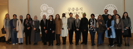 Spouses of foreign ambassadors to Korea pose for photos at an exhibition ″Joseon's Royal Cuisine: A Table for Food, Reverence and Sharing″ at the National Palace Museum of Korea in central Seoul on Tuesday. [YONHAP]