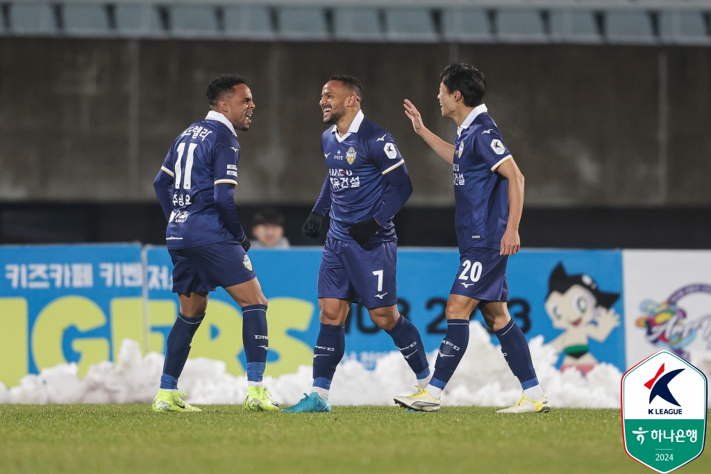 Denisson Silva of Chungnam Asan FC, center, celebrates with teammates Juninho Rocha, left, and An Yong-woo after scoring a goal against Daegu FC during the teams' K League promotion-relegation playoff match at Cheonan Stadium in Cheonan, South Chungcheong, on Nov. 28. [KOREA PROFESSIONAL FOOTBALL LEAGUE]