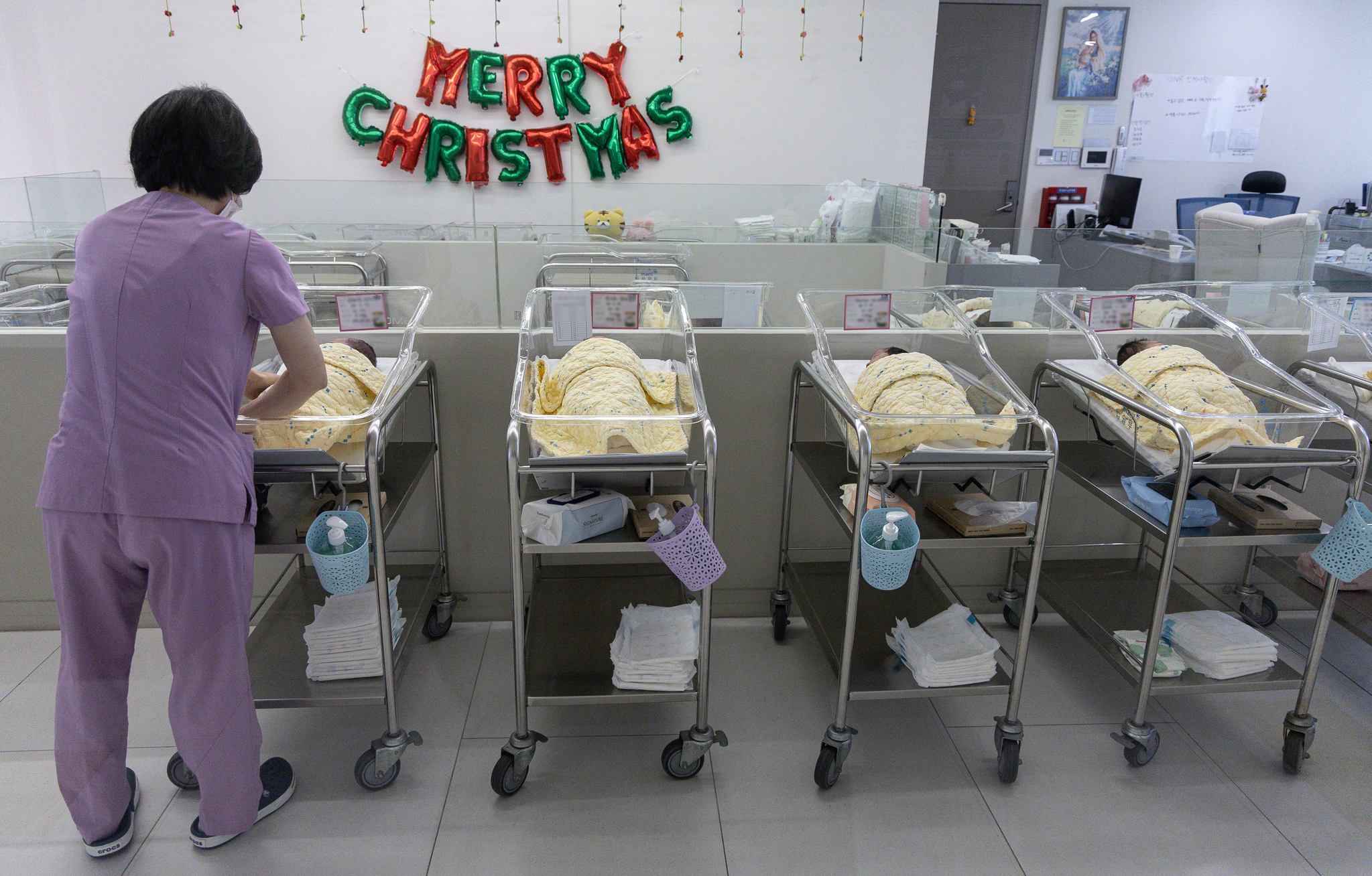 A nurse take cares of newborn babies in a hospital in Seoul last month. [NEWS1]