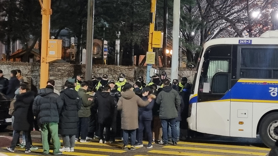 Citizens gather outside the National Assembly gates in western Seoul on Dec. 3 after President Yoon Suk Yeol declares an emergency martial law. [YOON SO-YEON]