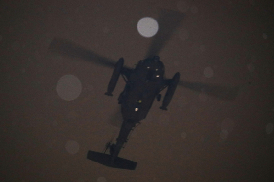 A military helicopter flies to the National Assembly building in western Seoul late Tuesday night after President Yoon Suk Yeol declared emergency martial law that day. [NEWS1]